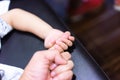 A boy is holding his parent finger to show his trust and believe Royalty Free Stock Photo