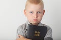 Boy holding Holy Bible Royalty Free Stock Photo