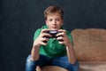 Boy holding joystick and playing video game, Resting At Home. Focus on Wireless Controller Royalty Free Stock Photo