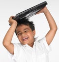 Boy holding laptop on his head Royalty Free Stock Photo