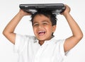 Boy holding laptop on his head Royalty Free Stock Photo