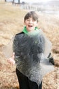 Boy Holding A Large Sheet of Ice from Lake