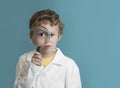 Boy holding magnifying glass to eye Royalty Free Stock Photo