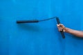 Boy holding Nunchaku on his hand isolated on Blue background. Black nunchaku training for beginner. Hot Tactical Gear Martial Arts