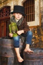The boy is holding an old kerosene lamp in his hands. Stylized retro portrait Royalty Free Stock Photo
