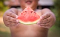 Boy holding out a sliced water melon Royalty Free Stock Photo