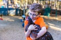 Boy holding pet chicken in coop Royalty Free Stock Photo