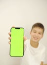 boy holding phone mockup in vertical position. Person using smartphone for showing photo or information. empty screen Royalty Free Stock Photo