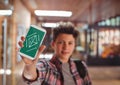 Boy holding a phone with school icons on screen Royalty Free Stock Photo