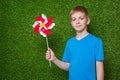 Boy holding pinwheel over grass Royalty Free Stock Photo