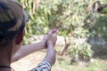 Boy holding a self-made gun toy made from colorful popsicle sticks with rubber band. Royalty Free Stock Photo