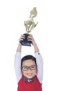 Boy holding trophy above his head - isolated Royalty Free Stock Photo