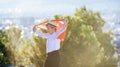 Boy holding Turkey flag against city. Kid hand waving Turkish flag view from back, copy space for text