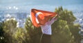 Boy holding Turkey flag against city. Kid hand waving Turkish flag view from back, copy space for text