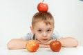 Boy holds a apples, healthy food and vitamins, smiling, white background. Joyful boy with a red apple on an isolated Royalty Free Stock Photo