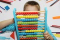 The boy holds big abacus in his hands. The boy loves math Royalty Free Stock Photo