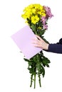 Boy holds a bouquet of yellow and pink chrysanthemums and empty greeting card in his hands. ÃÂ¡oncept holiday greeting.