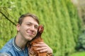 The boy holds a chicken in his hands and hugs her Royalty Free Stock Photo