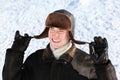 Boy holds on cordages ear-flaps hat Royalty Free Stock Photo