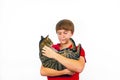 Boy holds his tabby cat in his arms Royalty Free Stock Photo