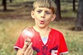 The boy holds an incandescent light bulb, which burns in his hand and looks at her with surprise and admiration