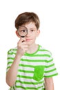 The boy holds loupe opposite his eye Royalty Free Stock Photo