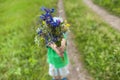 The boy holds out a bouquet. Royalty Free Stock Photo