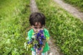 The boy holds out a bouquet. Royalty Free Stock Photo