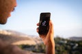 A boy holds a smartphone with the TikTok logo, it`s a very popular app and a video-focused social networking service