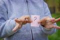 the boy holds stickers with a question mark on the background of the park. selective focus Royalty Free Stock Photo