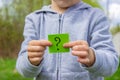 the boy holds stickers with a question mark on the background of the park. selective focus Royalty Free Stock Photo