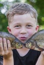 Boy holds two fish bream Royalty Free Stock Photo