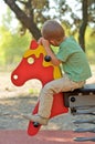 Boy on a horse on a playground Royalty Free Stock Photo