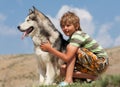 Boy hugging a fluffy dog Royalty Free Stock Photo