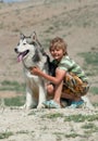 Boy hugging a fluffy dog Royalty Free Stock Photo