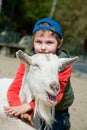 Boy hugging a goat Royalty Free Stock Photo