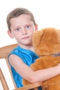 Boy hugging stuffed bear