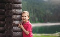 Boy hugging a tree house near the lake Royalty Free Stock Photo