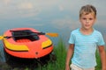 Boy and inflatable boat ashore Royalty Free Stock Photo