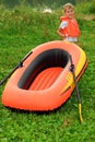 Boy and inflatable boat on lawn Royalty Free Stock Photo