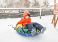 Boy with the inflatable sledge, snow tube