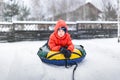 Boy with the inflatable sledge, snow tube