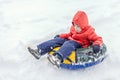 Boy with the inflatable sledge, snow tube