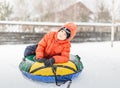 Boy with the inflatable sledge, snow tube