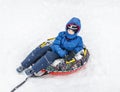 Boy with the inflatable sledge, snow tube