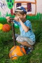 Boy inflates soccer ball pump Royalty Free Stock Photo