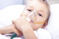 Boy with an inhaler mask - respiratory problems in asthma