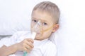 Boy with an inhaler mask - respiratory problems in asthma