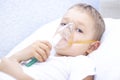 Boy with an inhaler mask - respiratory problems in asthma