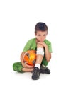 Boy with injured leg and soccer ball Royalty Free Stock Photo